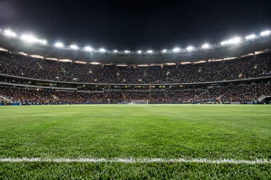 Estádio de futebol iluminado à noite durante jogo do Campeonato Brasileiro, em referência à vitória do Flamengo sobre o Corinthians.